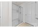 A sleek, modern shower with glass doors and white tiled walls providing a clean and bright space at 6702 Carradale Way, Charlotte, NC 28278