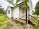 Exterior view showcases a wooden staircase leading to the back porch and home's siding and fixtures at 712 N Washington St, Shelby, NC 28150