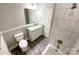 A well-lit bathroom features a granite vanity, tile shower, and modern fixtures at 712 N Washington St, Shelby, NC 28150
