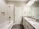 A full bathroom with a double vanity, tile shower, and plenty of natural light at 712 N Washington St, Shelby, NC 28150