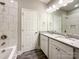 A full bathroom with a double vanity, tile shower, and plenty of natural light at 712 N Washington St, Shelby, NC 28150