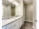 A full bathroom with a double vanity, tile shower, and plenty of natural light at 712 N Washington St, Shelby, NC 28150