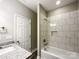 A modern bathroom with granite countertops, a tiled shower-tub, and neutral decor at 712 N Washington St, Shelby, NC 28150