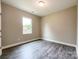 This bedroom features wood-look floors, a neutral color scheme, and a bright window at 712 N Washington St, Shelby, NC 28150