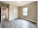 This bedroom features wood-look floors, a neutral color scheme, and a bright window at 712 N Washington St, Shelby, NC 28150