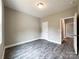 A cozy bedroom featuring wood floors, neutral paint, and a door that opens to reveal connecting rooms at 712 N Washington St, Shelby, NC 28150