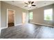 Large bedroom featuring hardwood floors, a ceiling fan, and a walk-in closet at 712 N Washington St, Shelby, NC 28150