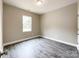 A simple bedroom with gray walls, dark floors, one window, and white trim and doors at 712 N Washington St, Shelby, NC 28150