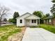 Charming single-story home with white siding, a cozy front porch, and a concrete driveway at 712 N Washington St, Shelby, NC 28150