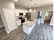 An open-concept kitchen with an island, stainless steel appliances, and white cabinets at 712 N Washington St, Shelby, NC 28150
