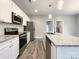 A modern kitchen boasts stainless steel appliances, white cabinets, and granite countertops at 712 N Washington St, Shelby, NC 28150