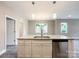 A kitchen island featuring white cabinets and granite countertops with stainless steel appliances at 712 N Washington St, Shelby, NC 28150