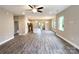 Open-concept living room flows into the kitchen, featuring wood-look floors and natural light from many windows at 712 N Washington St, Shelby, NC 28150