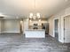 Open concept living space with kitchen island, stainless appliances, and wood floors at 712 N Washington St, Shelby, NC 28150