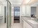 Bright bathroom with a double vanity, large mirror, and access to the bedroom at 8251 Tradd Ct, Charlotte, NC 28210