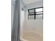 A lovely bathroom with a shower and a window at 8251 Tradd Ct, Charlotte, NC 28210
