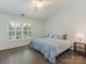 Bright bedroom with hardwood floors, a window with shutters, and a ceiling fan at 8251 Tradd Ct, Charlotte, NC 28210