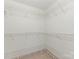 Walk-in closet with white wire shelving to maximize storage space at 8251 Tradd Ct, Charlotte, NC 28210
