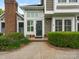 Close-up of front door with beautiful landscaping and well-maintained walkway at 8251 Tradd Ct, Charlotte, NC 28210