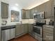 Kitchen with stainless steel appliances, granite countertops and white backsplash at 8251 Tradd Ct, Charlotte, NC 28210