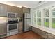 Kitchen with stainless steel appliances and plantation shutters at 8251 Tradd Ct, Charlotte, NC 28210