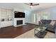 Cozy living room with a fireplace, built-in shelving, and French doors at 8251 Tradd Ct, Charlotte, NC 28210