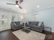 Cozy living room featuring comfortable sofas, soft rug, and a ceiling fan for added comfort at 8251 Tradd Ct, Charlotte, NC 28210