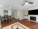 Open-concept living room with dining table and cozy fireplace at 8251 Tradd Ct, Charlotte, NC 28210