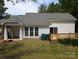 Backyard featuring a wooden deck, white siding, and mature trees at 8332 Highlander Ct, Charlotte, NC 28269