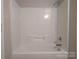 Clean, white bathtub featuring a standard shower head and faucet at 8332 Highlander Ct, Charlotte, NC 28269