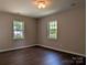 Bedroom with natural light from two windows and laminate flooring provides a cozy retreat at 8332 Highlander Ct, Charlotte, NC 28269