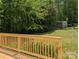 Wooden deck overlooking a green backyard with a small shed in the distance at 8332 Highlander Ct, Charlotte, NC 28269