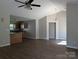 Open floor plan featuring updated flooring and bright lighting connects living and kitchen spaces at 8332 Highlander Ct, Charlotte, NC 28269
