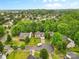An aerial view shows the neighborhood with mature trees, well-kept lawns, and houses at 9010 Davis Crossing Ct, Charlotte, NC 28269