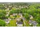 An aerial view shows the neighborhood with mature trees, well-kept lawns, and houses at 9010 Davis Crossing Ct, Charlotte, NC 28269