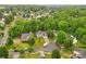 An aerial view shows the neighborhood with mature trees, well-kept lawns, and houses at 9010 Davis Crossing Ct, Charlotte, NC 28269