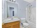 Standard bathroom with a single sink vanity, mirror, and a shower-tub combination at 9010 Davis Crossing Ct, Charlotte, NC 28269