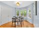 Bright dining area features wood floors, a modern light fixture, and three large windows at 9010 Davis Crossing Ct, Charlotte, NC 28269