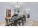 Cozy dining room featuring a stylish chandelier, neutral walls, and an elegant black table at 9010 Davis Crossing Ct, Charlotte, NC 28269