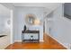 Inviting entryway featuring hardwood floors, neutral walls, stylish console table and decorative mirror at 9010 Davis Crossing Ct, Charlotte, NC 28269
