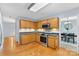 Well-lit kitchen featuring hardwood floors, wood cabinetry, stainless steel appliances, and modern countertops at 9010 Davis Crossing Ct, Charlotte, NC 28269