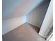 Attic space with angled ceiling and tan carpeting at 904 3Rd Street Ne Pl, Conover, NC 28613