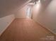 Spacious carpeted attic with natural light and neutral walls at 904 3Rd Street Ne Pl, Conover, NC 28613