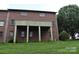 Brick home with a partially covered back porch overlooking a well-maintained lawn at 904 3Rd Street Ne Pl, Conover, NC 28613