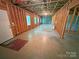 Unfinished basement with windows, door, and exposed framing for customization at 904 3Rd Street Ne Pl, Conover, NC 28613