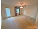 Bedroom featuring plush carpeting, a fan, and a door to the outside at 904 3Rd Street Ne Pl, Conover, NC 28613