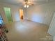 Large bedroom with carpet, fan, closet, and ensuite access at 904 3Rd Street Ne Pl, Conover, NC 28613