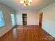 The dining room has hardwood floors, a chandelier, a window, and a view into the kitchen at 904 3Rd Street Ne Pl, Conover, NC 28613