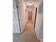 Carpeted hallway featuring multiple doorways and neutral wall paint at 904 3Rd Street Ne Pl, Conover, NC 28613