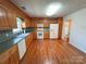 Spacious kitchen boasts wood cabinets, white appliances, and hardwood floors at 904 3Rd Street Ne Pl, Conover, NC 28613